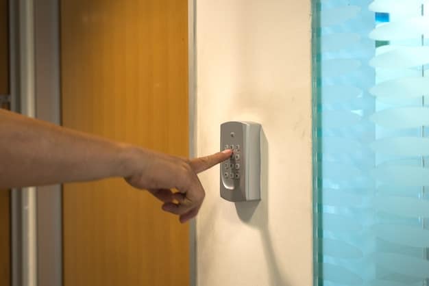 A close-up of a smart doorbell mounted on a door frame, showing its camera and button illuminated. A hand reaches out to press the button.