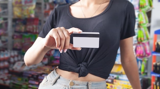 Close-up of a woman's hand holding a credit card, with a blurred background of a beauty store's shelves filled with products, symbolizing the use of credit card rewards for beauty purchases.