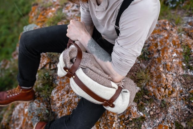 A person cleaning a portable Bluetooth speaker with a soft cloth after a muddy hiking trip, showing the speaker's durable design.