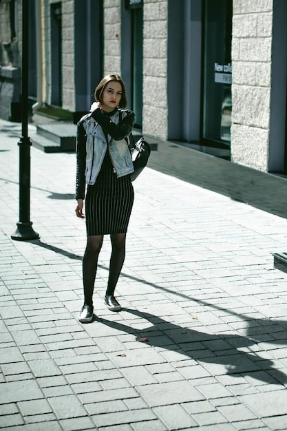 A stylish woman confidently walking down a bustling city street, wearing Shein's high-waisted black seamless leggings, a cropped ribbed tank top, an oversized neutral-toned blazer, and crisp white fashion sneakers, carrying a minimalist tote bag.