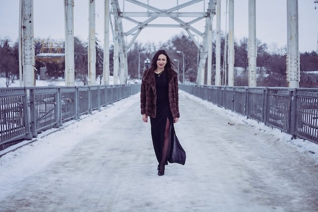 A person walking in a snowy urban environment, dressed in a stylish layered winter outfit featuring a thick puffer coat, a visible turtleneck sweater underneath, warm beanie, and scarf, exuding comfort and warmth.