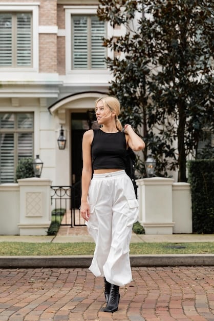 A woman wearing a chic casual outfit, featuring a flowy top and tailored trousers, paired with stylish and comfortable Shein loafers as she walks down a city street, emphasizing everyday wear.