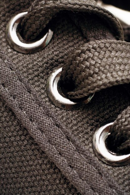 A detailed close-up of a pair of stylish Shein sneakers with unique lacing and a subtle patterned design, suitable for athletic activities or casual street style.