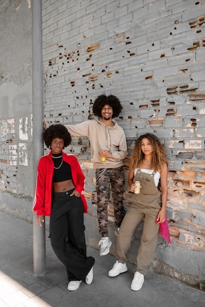 A diverse group of people, dressed in stylish gender-fluid clothing with relaxed fits and a neutral color palette, interacting in a vibrant urban setting, showcasing comfort and self-expression.