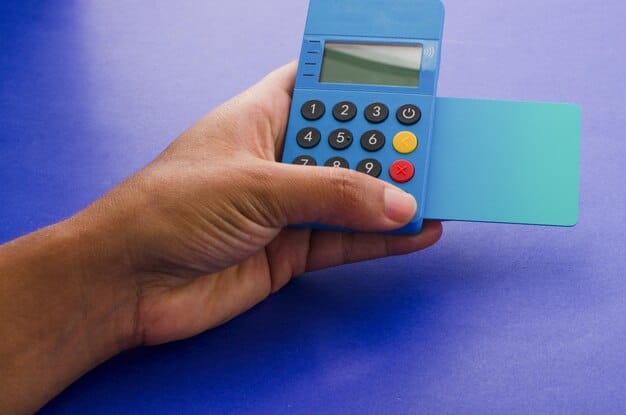 A hand using a calculator while shopping with credit cards and reviewing his expanse.