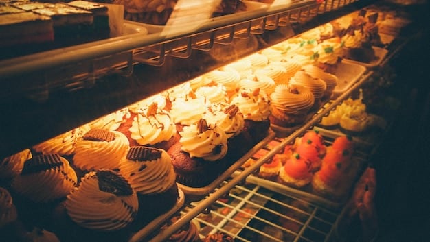 A bakery display with a variety of fresh-baked goods. The warm lighting and inviting aroma create an appealing sensory experience, encouraging customers to make a purchase and illustrating the role of sensory marketing in the psychology of shopping.