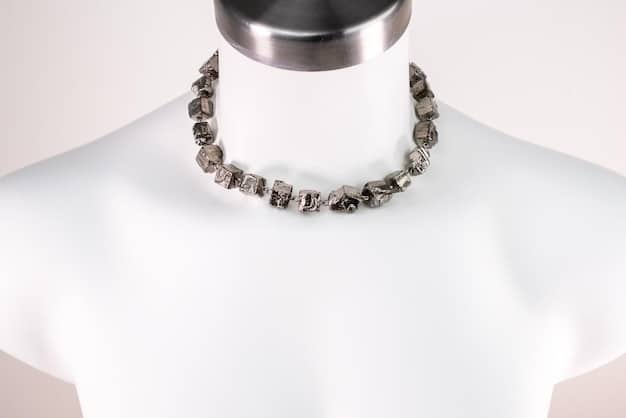 A display of layered necklaces on a mannequin's neck. The necklaces vary in length, material, and style. There are delicate gold chains, pendant necklaces with gemstones, and chunkier beaded necklaces. The focus is on how the different necklaces complement each other.