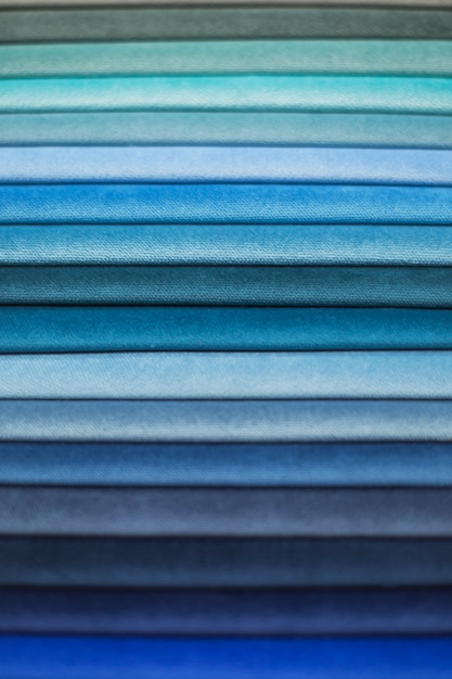 A close-up shot of fabric swatches displaying various shades of blue predicted to be popular in the Spring 2025 fashion season. The focus is on texture and tone differentiation, showcasing how Classic Blue can be reimagined in numerous ways. Captures different fabric types from silk to denim, all in the predicted hues for 'Spring 2025 Fashion Forecast: 7 Must-Have Colors Dominating US Runways'.
