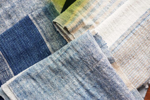 A close-up shot of various denim fabrics showcasing different textures and washes, used in sustainable denim production. The image highlights the use of recycled denim, organic cotton, and waterless washing techniques, emphasizing the eco-friendly aspect of 'Denim Redefined: The Latest Denim Trends Taking Over the US Fashion Scene'.