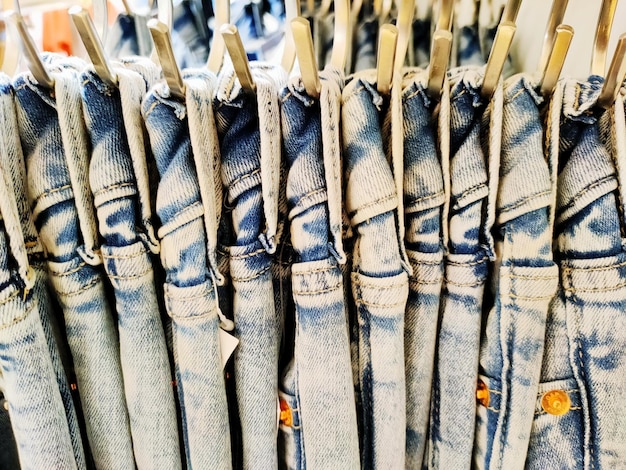 A curated collection of upcycled denim garments, including patchwork jeans, reconstructed denim jackets, and reworked denim skirts, displayed in a brightly lit, modern boutique. The image emphasizes the creativity and sustainability of upcycled denim in 'Denim Redefined: The Latest Denim Trends Taking Over the US Fashion Scene'.
