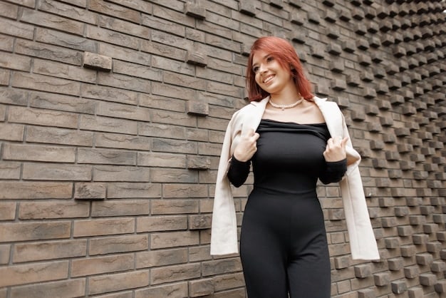A plus-size model smiling confidently while wearing a stylish outfit that accentuates her curves. She is standing in front of a minimalist background, emphasizing the body positivity in fashion: celebrating diversity and inclusivity in US styles.