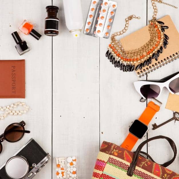 A flat lay showcasing a curated selection of affordable accessories such as scarves, belts, jewelry, and hats. The accessories are arranged to highlight their versatility and potential to elevate various outfits, emphasizing fashion on a budget.