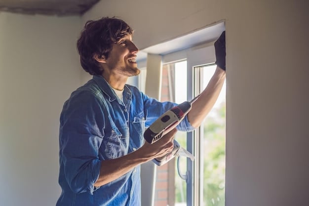 A window installer carefully fitting an energy-efficient window into a home's frame. The installer is using tools to ensure a tight seal and proper alignment, highlighting the importance of professional installation for Energy-Efficient Windows: How to Save Up to 15% on Your Home Heating Bills This Winter.