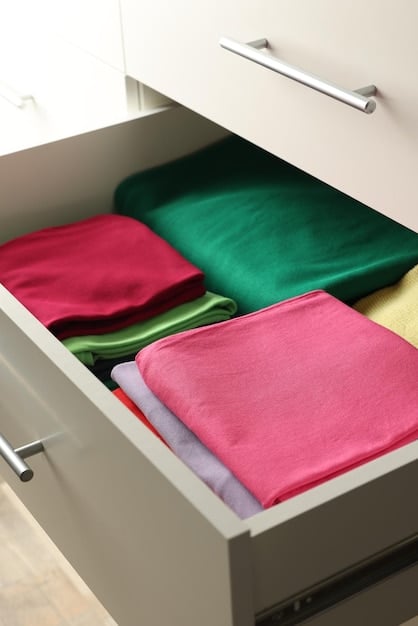 A close-up shot of a neatly organized drawer with folded clothes using the KonMari method, highlighting the vertical folding technique to maximize space and visibility.