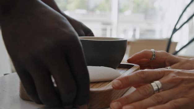 A close-up image of a US professional's hands gently resting on their lap during a mindful breathing exercise in an office setting. The focus is on the hands and the subtle sense of calm. The image supports the idea of reducing stress through mindfulness, showing a moment of peace amidst the work environment.