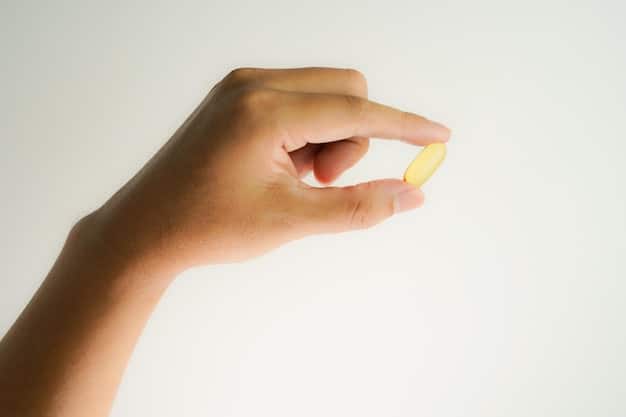 A close-up shot of a person's hand holding a vitamin D supplement capsule. The background should be blurred, focusing on the capsule and the texture of the hand. The lighting should be soft and natural. The image should relate to the importance of vitamin D in maintaining a strong immune system during winter, reinforcing Boost Your Immunity: 5 Essential Supplements for US Residents This Winter.