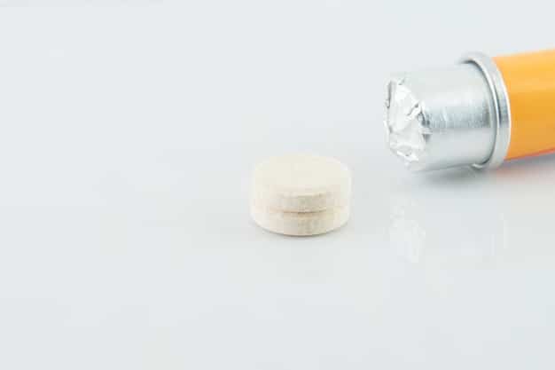 A high-angle shot of a small, opened bottle of zinc lozenges with a few lozenges scattered around it. The background should be a clean, wooden surface with a cup of warm tea. The lighting should be warm and inviting. The image should convey the idea of soothing a sore throat while boosting the immune system, emphasizing the support Zinc provides during winter.