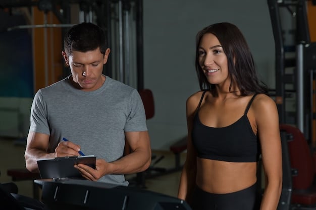 Gym environment. Focus on US Personal trainer showing workout planning to client. Exercise for Beginners: A 30-Day Plan to Get Active and Feel Great in the US
