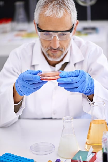 A close-up shot of a scientist in a lab coat examining a petri dish containing a viral culture, with sophisticated lab equipment in the background. The focus is on the scientific research dedicated to tracking and understanding The Latest on COVID-19: New Variants and Updated Vaccine Recommendations for the US.