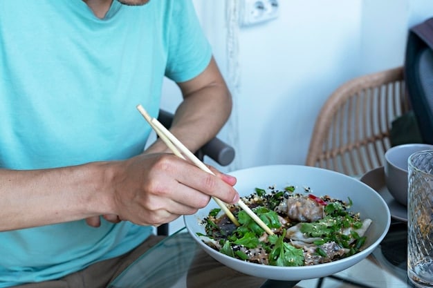 A person mindfully eating a salad at a table, using chopsticks to pick up each bite slowly and deliberately. Their expression is calm and focused, reflecting the practice of mindful eating and its relation to How to Build a Healthy Relationship with Food: Tips for Overcoming Emotional Eating.