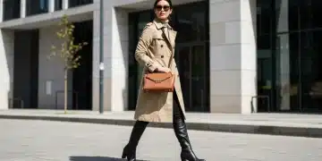 Woman in classic trench coat and leather boots on city street