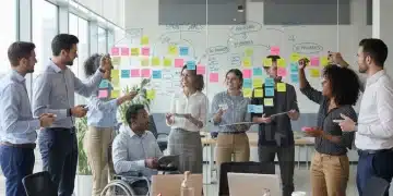 Agile team collaborating on project board with sticky notes