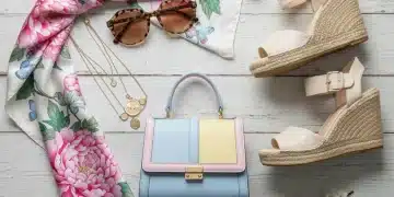 Spring style accessories flat lay with pastel handbag, delicate necklaces, and floral scarf